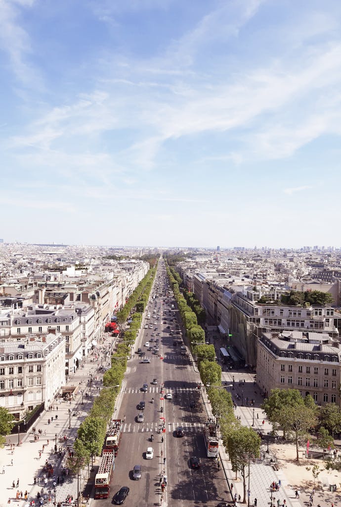 Aerial shot of the iconic Champs-Élysées in Paris on a clear summer day.