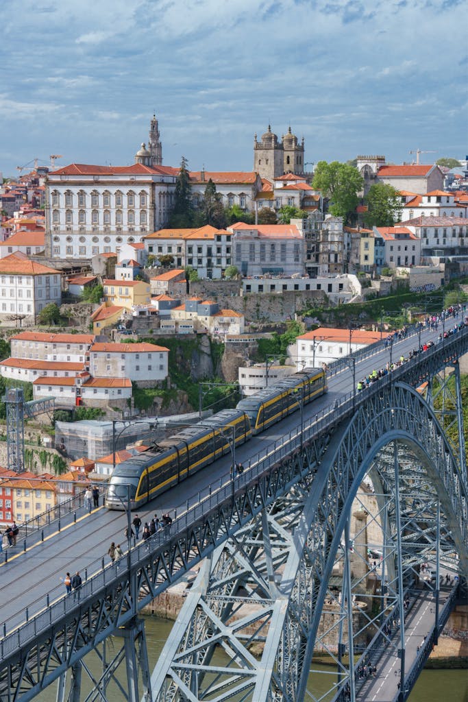 Aerial view of Dom Luis I Bridge and trams in Porto, Portugal. Iconic cityscape.