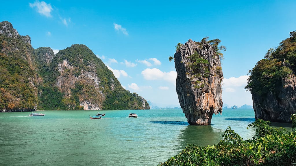 Scenic view of James Bond Island in Thailand with boats and turquoise water.