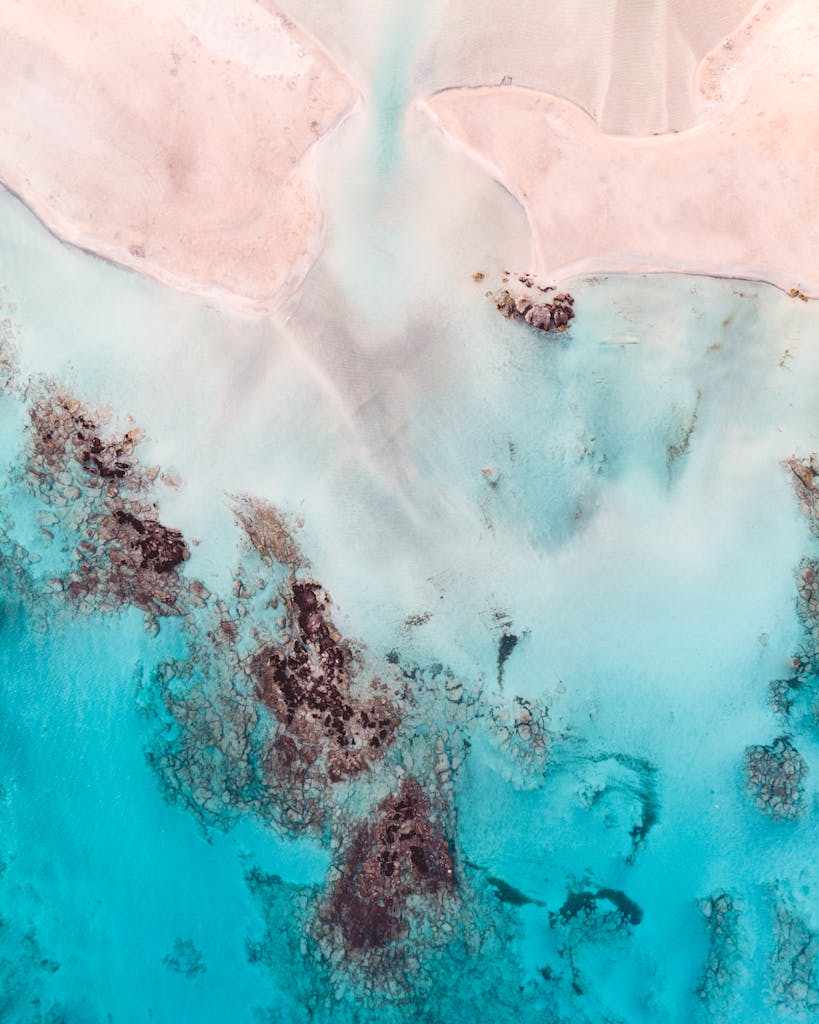 Stunning aerial view of Elafonissi Beach's turquoise waters and sandy shores in Crete, Greece.