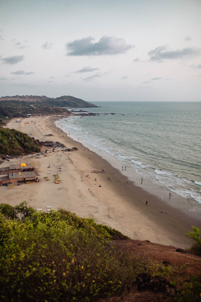 Scenic aerial view of Chapora Beach, Goa, showcasing sandy shores and ocean waves.